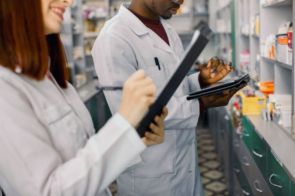 A pharmacy program manager or healthcare admin reviewing a clean, modern software dashboard on a laptop or desktop — charts, claims data, or analytics visible.